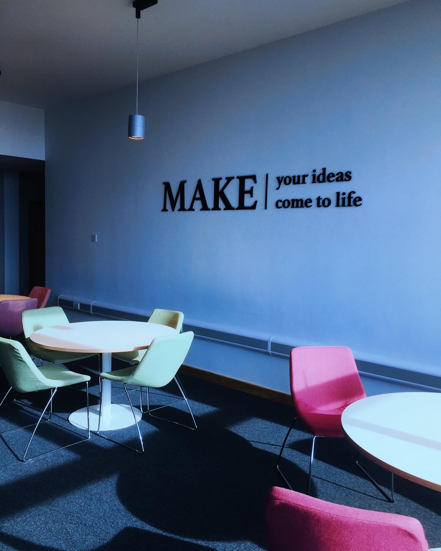 Colourful chairs and tables in a quiet workspace